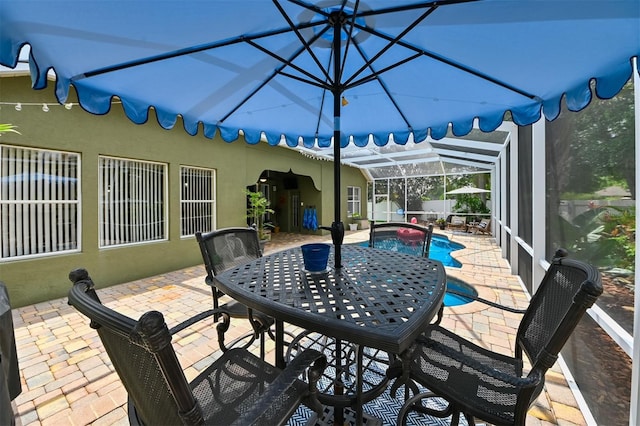 view of patio featuring a lanai, a fenced in pool, and fence