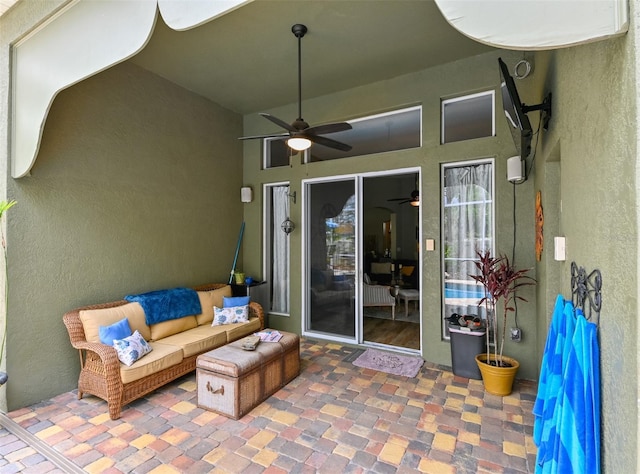 view of patio with an outdoor living space and ceiling fan