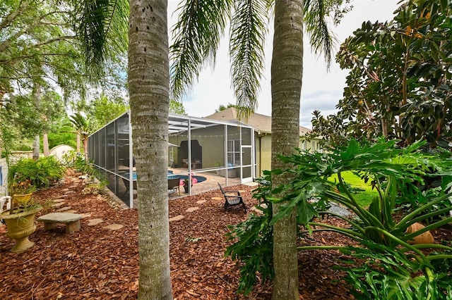 view of yard with a patio area, an outdoor pool, and a lanai