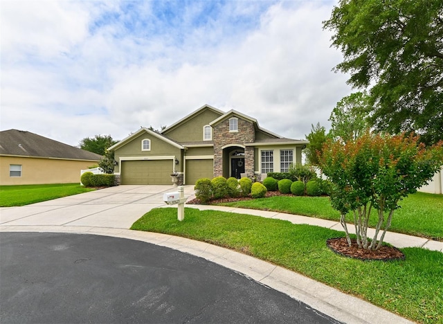 view of front of house with an attached garage, driveway, stone siding, and a front lawn