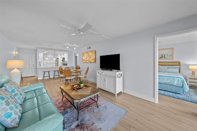 6051 Sun Blvd Unit 111, Saint Petersburg, FL 33715 - living area featuring baseboards, visible vents, ceiling fan, and light wood-style flooring