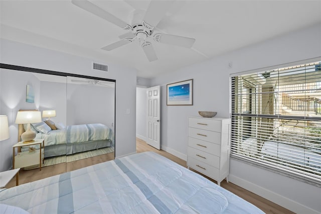 6051 Sun Blvd Unit 111, Saint Petersburg, FL 33715 - bedroom with wood finished floors, baseboards, multiple windows, and visible vents