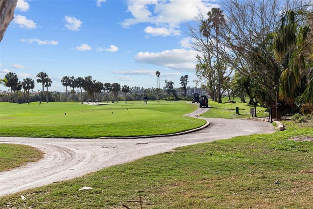 6051 Sun Blvd Unit 111, Saint Petersburg, FL 33715 - view of community with curved driveway and a lawn