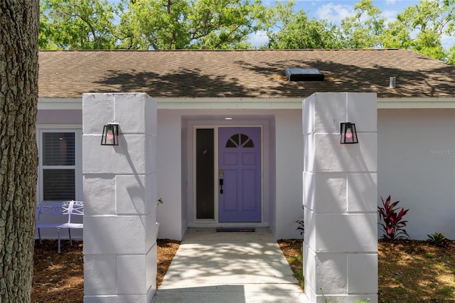 11368 93rd St, Largo, FL 33773 - doorway to property with a shingled roof and stucco siding