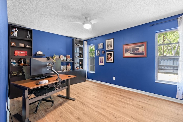 11368 93rd St, Largo, FL 33773 - office area featuring a textured ceiling, a ceiling fan, wood finished floors, and built in shelves