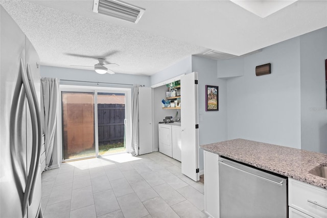 11368 93rd St, Largo, FL 33773 - kitchen featuring freestanding refrigerator, ceiling fan, stainless steel dishwasher, white cabinetry, and washer and clothes dryer