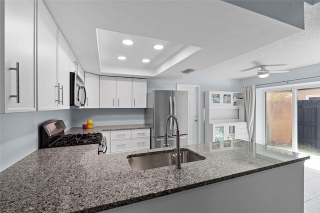 11368 93rd St, Largo, FL 33773 - kitchen featuring dark stone counters, stainless steel appliances, a peninsula, white cabinets, and recessed lighting