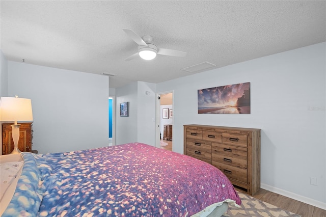 11368 93rd St, Largo, FL 33773 - bedroom featuring wood finished floors, a textured ceiling, and a ceiling fan