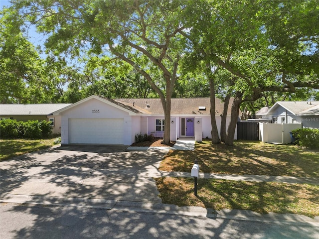 11368 93rd St, Largo, FL 33773 - ranch-style house featuring driveway, an attached garage, and stucco siding