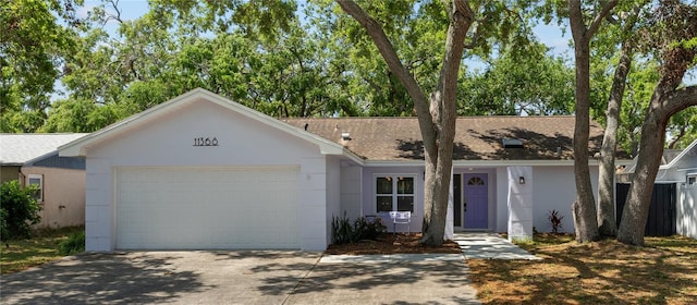11368 93rd St, Largo, FL 33773 - ranch-style home with driveway, a garage, stucco siding, and a shingled roof