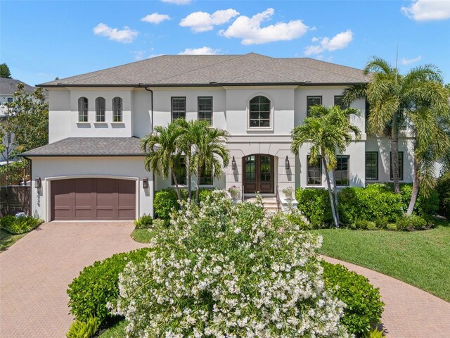 5025 W Homer Ave, Tampa, FL 33629 - mediterranean / spanish-style home with stucco siding, decorative driveway, a front lawn, french doors, and a garage