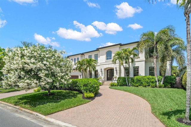 5025 W Homer Ave, Tampa, FL 33629 - mediterranean / spanish home with curved driveway, stucco siding, and a front yard