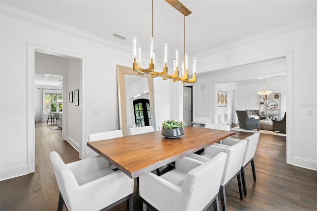 5025 W Homer Ave, Tampa, FL 33629 - dining room featuring visible vents, baseboards, a notable chandelier, ornamental molding, and dark wood-type flooring