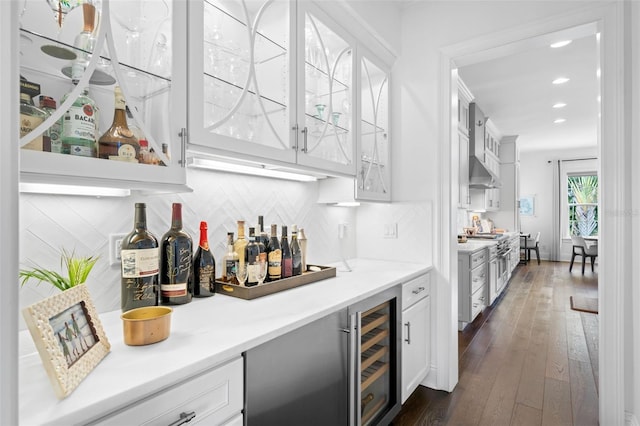 5025 W Homer Ave, Tampa, FL 33629 - bar with dark wood-style flooring, backsplash, wall chimney exhaust hood, beverage cooler, and bar