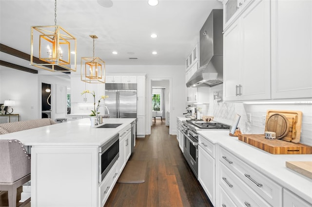 5025 W Homer Ave, Tampa, FL 33629 - kitchen with built in appliances, a notable chandelier, a kitchen breakfast bar, recessed lighting, and wall chimney exhaust hood