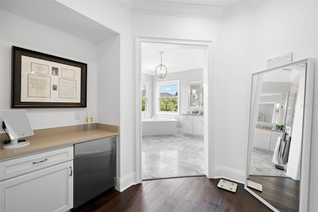 5025 W Homer Ave, Tampa, FL 33629 - bar with ornamental molding, a chandelier, marble finish floor, stainless steel fridge, and baseboards