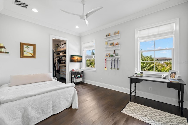 5025 W Homer Ave, Tampa, FL 33629 - bedroom with dark wood-style flooring, baseboards, ornamental molding, a spacious closet, and visible vents