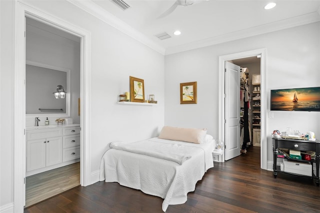 5025 W Homer Ave, Tampa, FL 33629 - bedroom with ornamental molding, a spacious closet, recessed lighting, dark wood-style floors, and visible vents