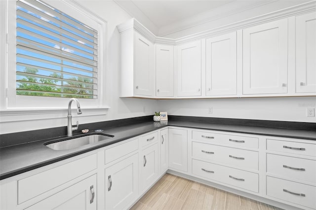 5025 W Homer Ave, Tampa, FL 33629 - kitchen featuring a sink, white cabinetry, and dark countertops