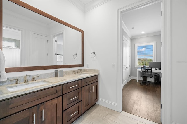 5025 W Homer Ave, Tampa, FL 33629 - bathroom featuring double vanity, a sink, ornamental molding, and baseboards