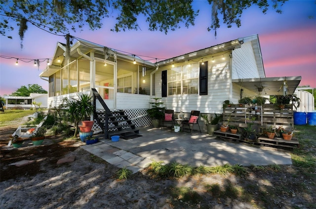 rear view of property with a sunroom