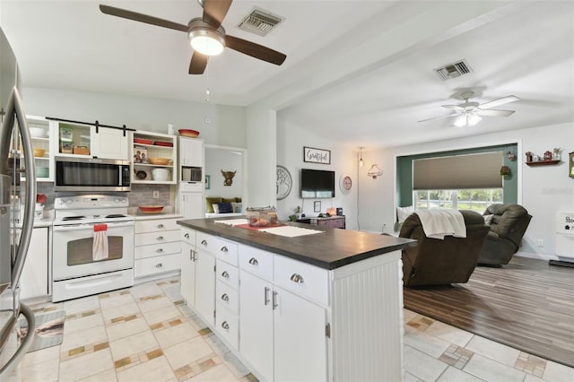 kitchen with visible vents, a ceiling fan, white cabinetry, and stainless steel appliances