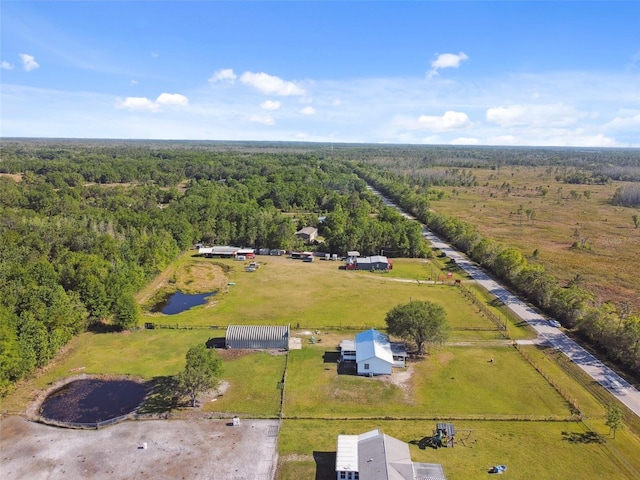 drone / aerial view featuring a wooded view and a rural view