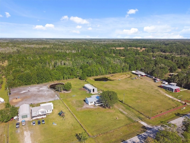 birds eye view of property featuring a wooded view and a rural view