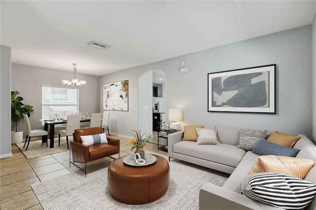 10524 White Peacock Pl, Riverview, FL 33578 - living area with arched walkways, a chandelier, light tile patterned floors, and baseboards