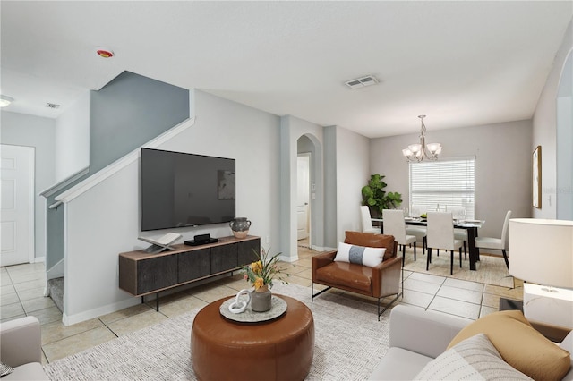 10524 White Peacock Pl, Riverview, FL 33578 - living area with arched walkways, light tile patterned flooring, a chandelier, stairway, and baseboards