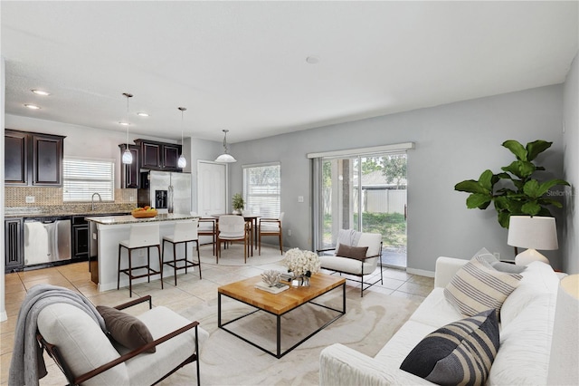 10524 White Peacock Pl, Riverview, FL 33578 - living room featuring light tile patterned flooring, recessed lighting, and baseboards