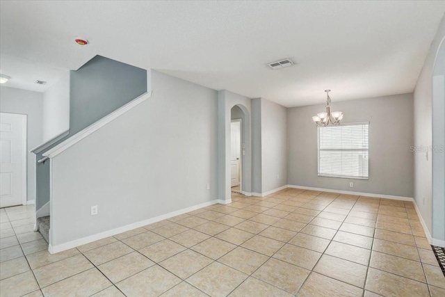 10524 White Peacock Pl, Riverview, FL 33578 - empty room featuring a chandelier, arched walkways, light tile patterned flooring, stairs, and baseboards