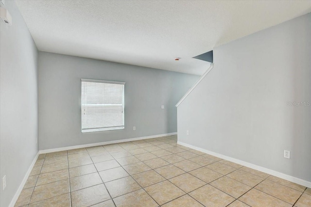 10524 White Peacock Pl, Riverview, FL 33578 - spare room featuring light tile patterned floors, a textured ceiling, and baseboards