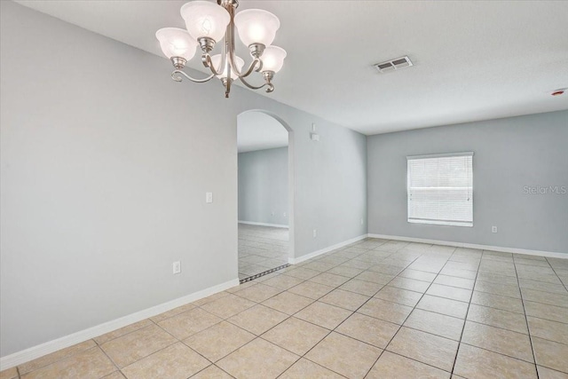 10524 White Peacock Pl, Riverview, FL 33578 - empty room featuring arched walkways, light tile patterned floors, a chandelier, and baseboards
