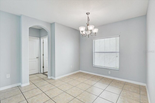 10524 White Peacock Pl, Riverview, FL 33578 - empty room with arched walkways, a chandelier, light tile patterned floors, and baseboards