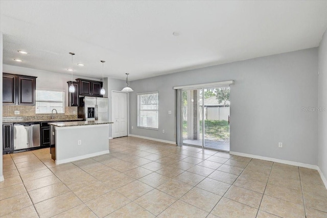 10524 White Peacock Pl, Riverview, FL 33578 - kitchen featuring appliances with stainless steel finishes, plenty of natural light, decorative backsplash, light tile patterned floors, and recessed lighting