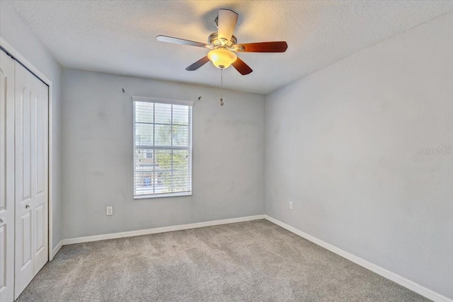 10524 White Peacock Pl, Riverview, FL 33578 - unfurnished bedroom with a closet, carpet floors, a textured ceiling, baseboards, and ceiling fan