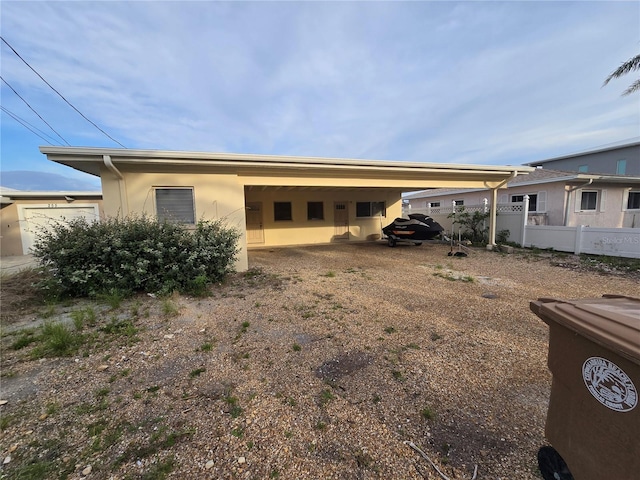 249 144th Ave, Madeira Beach, FL 33708 - view of front of house with stucco siding and an attached garage