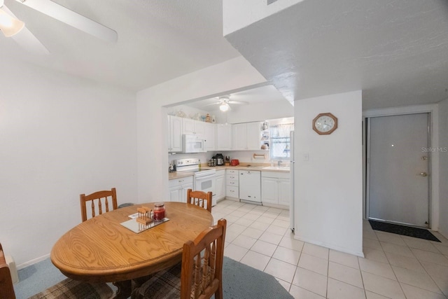 9945 47th Ave N Unit 203, Saint Petersburg, FL 33708 - dining area with light tile patterned flooring, baseboards, and a ceiling fan
