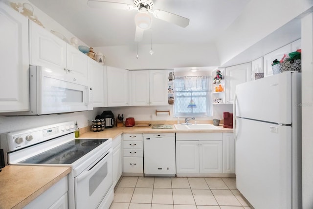 9945 47th Ave N Unit 203, Saint Petersburg, FL 33708 - kitchen with light countertops, a sink, light tile patterned floors, white appliances, and white cabinets