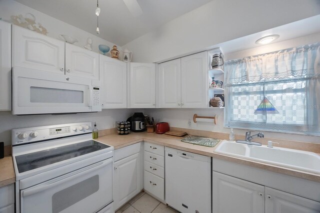 9945 47th Ave N Unit 203, Saint Petersburg, FL 33708 - kitchen with light countertops, white cabinets, a sink, and white appliances