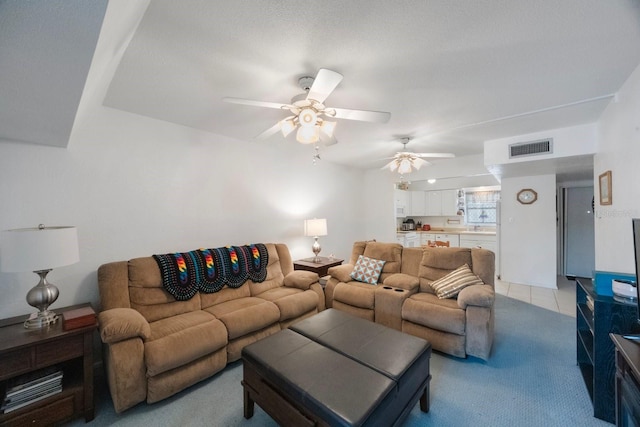 9945 47th Ave N Unit 203, Saint Petersburg, FL 33708 - living area with light colored carpet, visible vents, ceiling fan, and light tile patterned floors