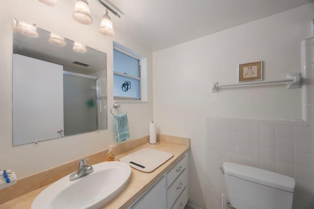 9945 47th Ave N Unit 203, Saint Petersburg, FL 33708 - bathroom with vanity, tile walls, toilet, an enclosed shower, and visible vents