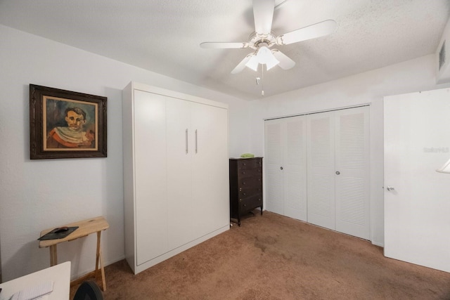 9945 47th Ave N Unit 203, Saint Petersburg, FL 33708 - bedroom featuring light colored carpet, a closet, ceiling fan, and a textured ceiling