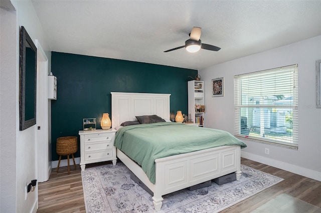 1601 14th St W, Palmetto, FL 34221 - bedroom with light wood finished floors, baseboards, and ceiling fan
