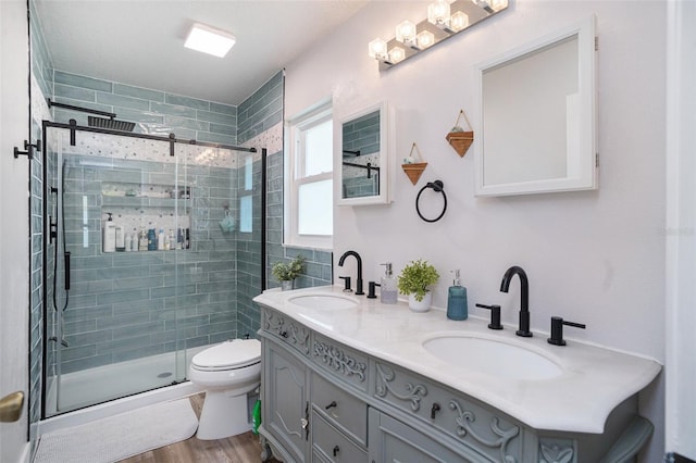 1601 14th St W, Palmetto, FL 34221 - full bath featuring double vanity, a shower stall, toilet, and wood finished floors
