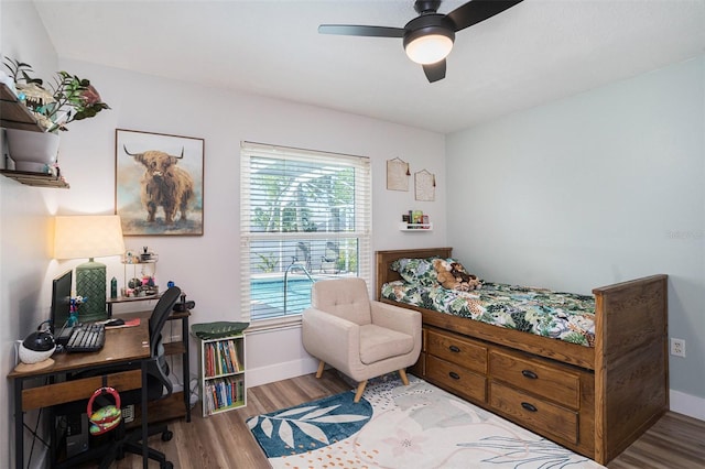1601 14th St W, Palmetto, FL 34221 - bedroom with wood finished floors, multiple windows, an office area, and baseboards
