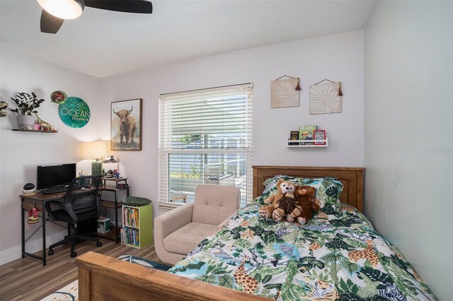1601 14th St W, Palmetto, FL 34221 - bedroom with an office area, wood finished floors, baseboards, and ceiling fan