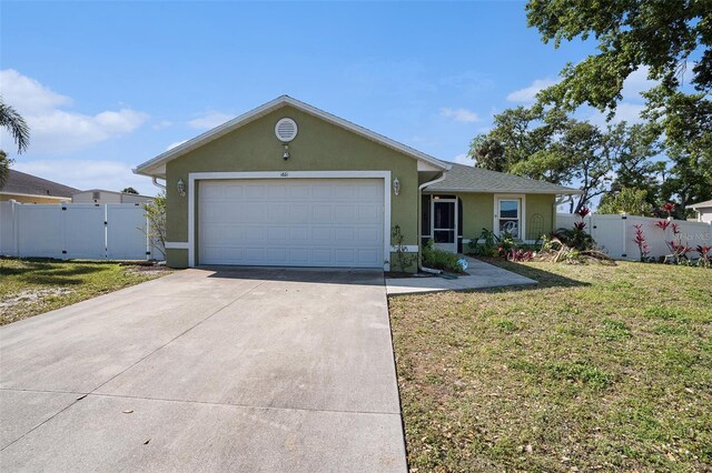 1601 14th St W, Palmetto, FL 34221 - single story home featuring stucco siding, concrete driveway, a gate, and an attached garage