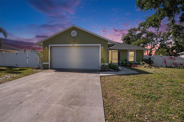 1601 14th St W, Palmetto, FL 34221 - single story home with driveway, stucco siding, an attached garage, and a gate
